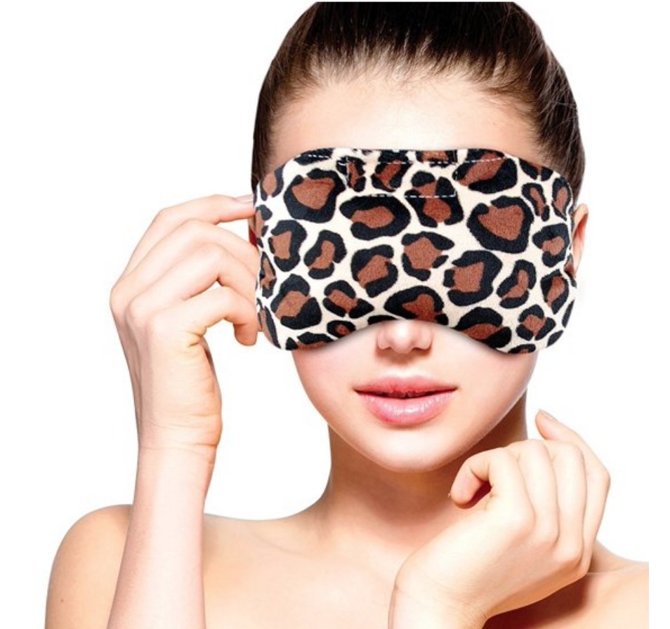 A model wearing a heated leopard eye mask