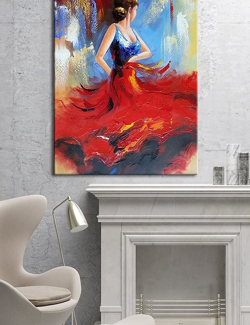 The painting above a fireplace mantle and chair