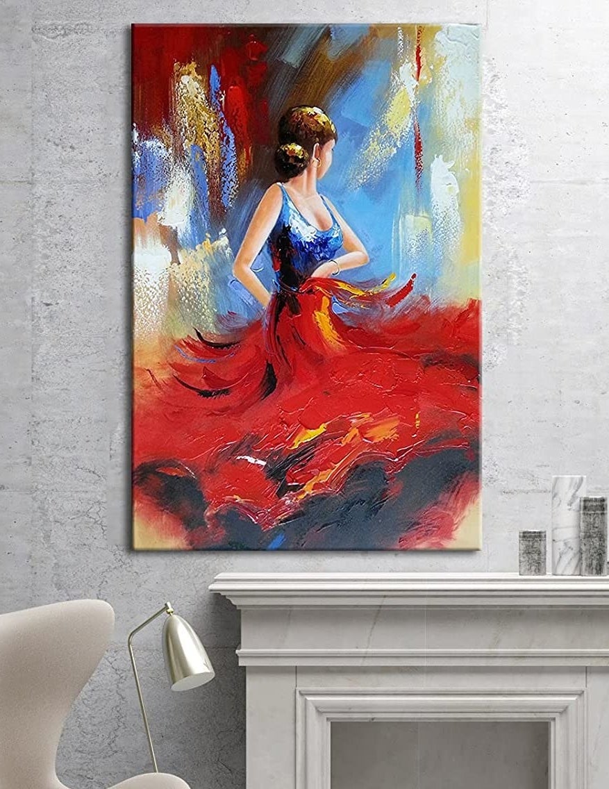 The painting above a fireplace mantle and chair