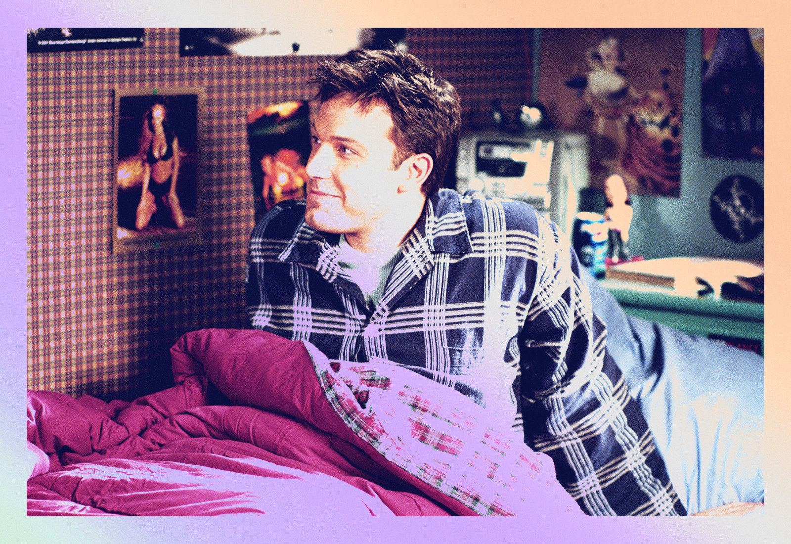 Ben Affleck in pajamas sits up in bed and smiles
