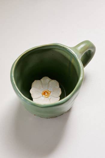 the flower peekaboo mug with a small flower sculpture at the bottom of the mug