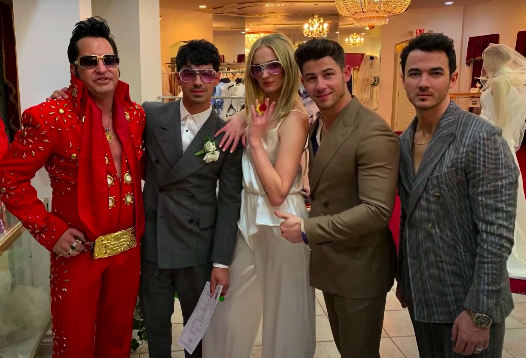 Elvis impersonator poses with the newlyweds and Nick and Kevin