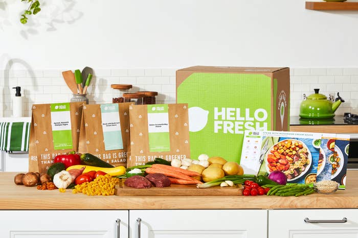 HelloFresh bags and box behind a row of vegetables