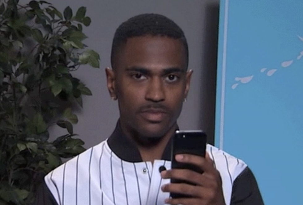 Big Sean looks up from his phone with a straight face