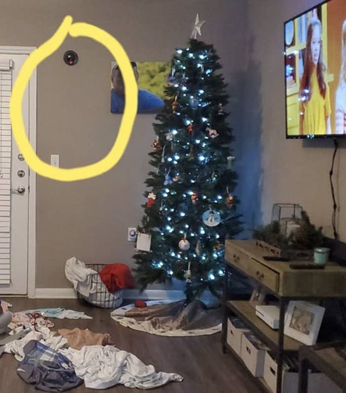 Fake camera on the wall near a Christmas tree circled