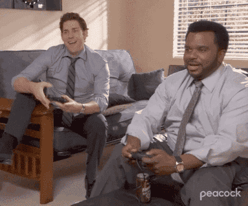 a gif of jim and darryl from the office playing playstation