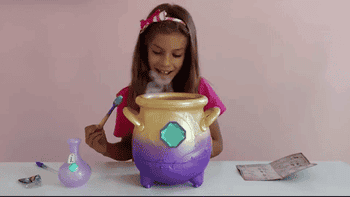 A gif of a child excited with the mist coming out of the cauldron