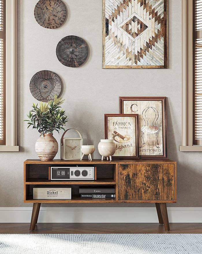 The unit with a bunch of vases and photo frames on it