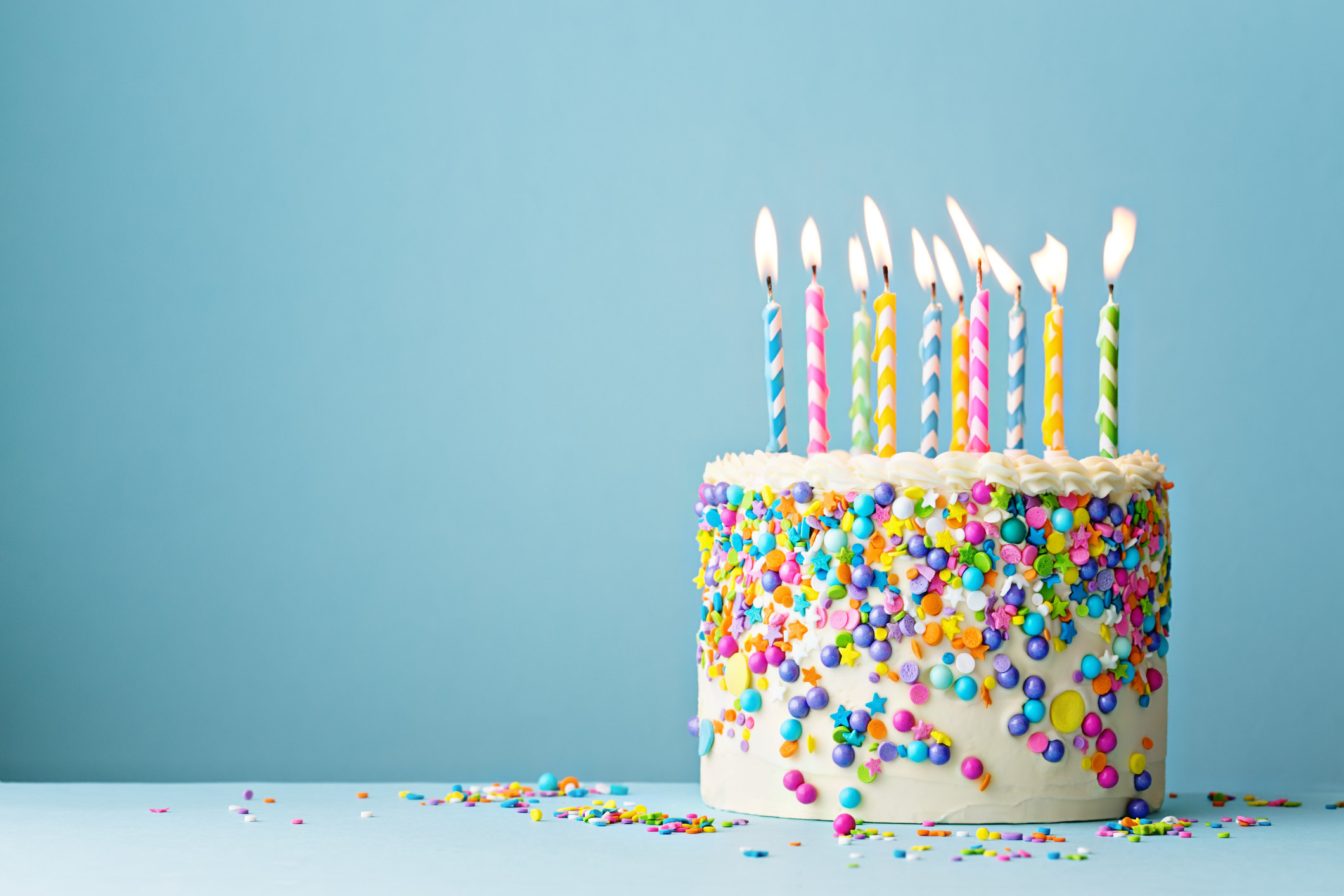 A birthday cake with several lit candles on it