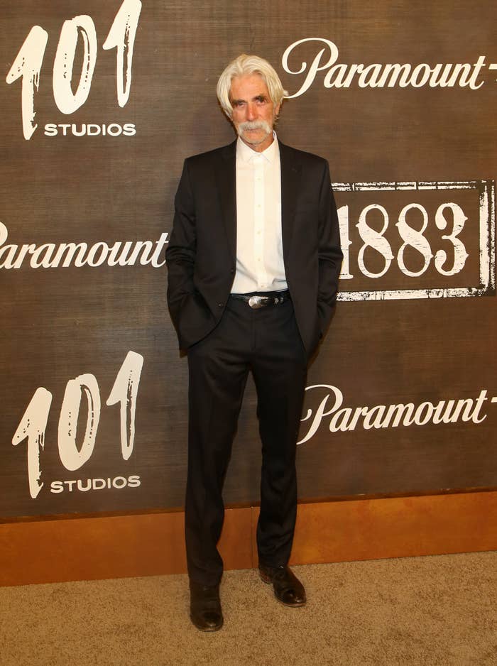 Sam Elliott poses at a step-and-repeat