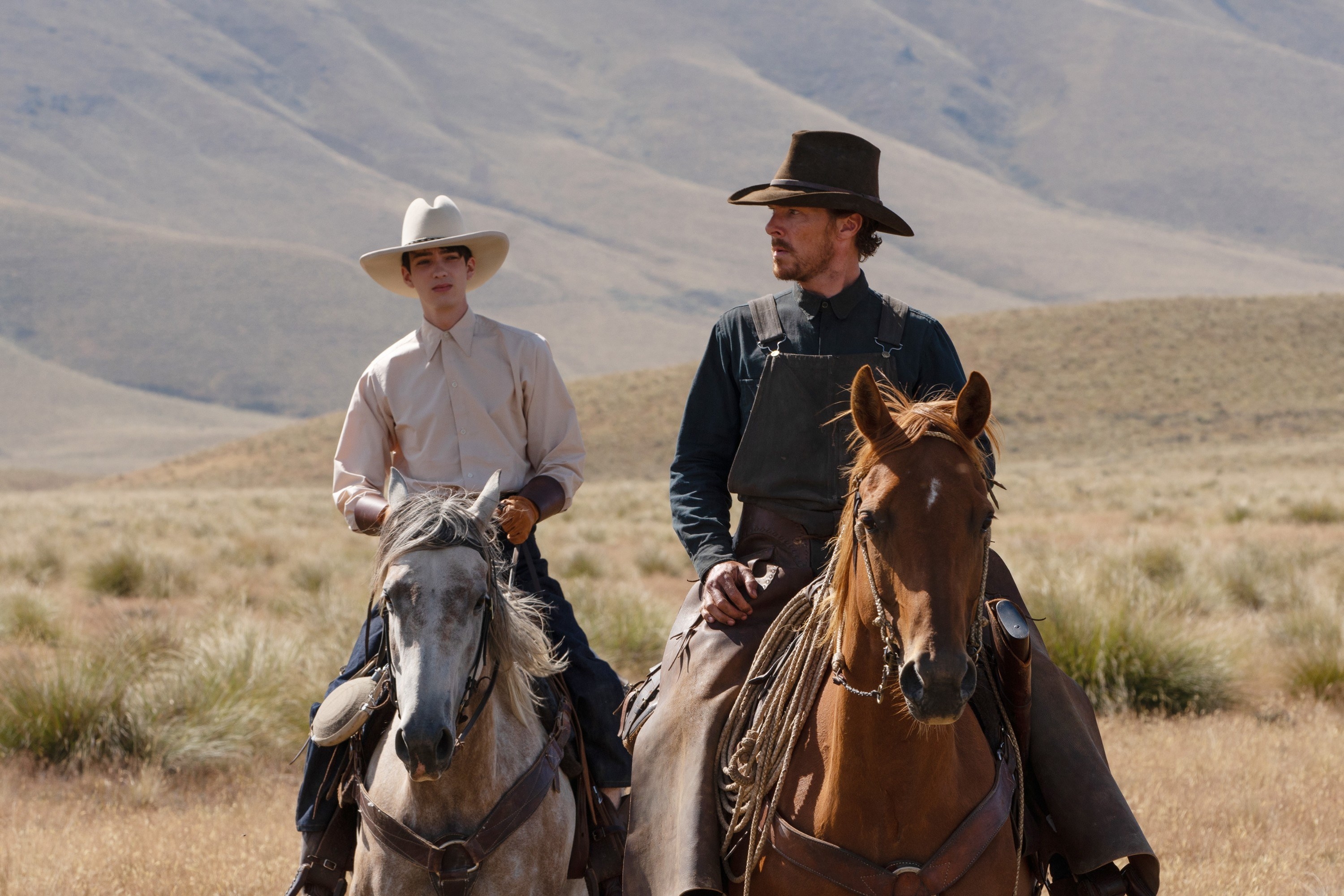 Benedict and Kodi Smit-McPhee ride horses together in a scene from the film