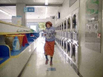 Woman dancing in a laundromat
