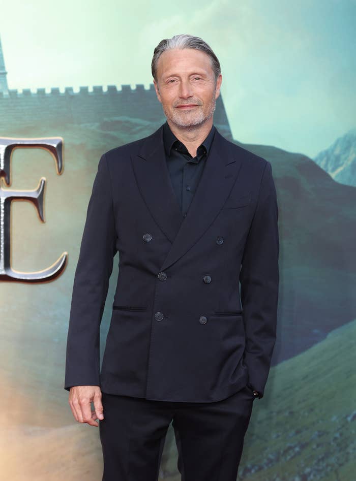 Mads smiles at a step-and-repeat