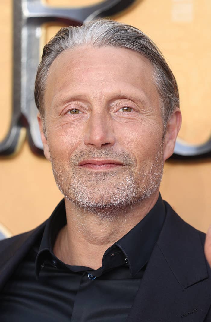 Mads smiles for the camera while at an event