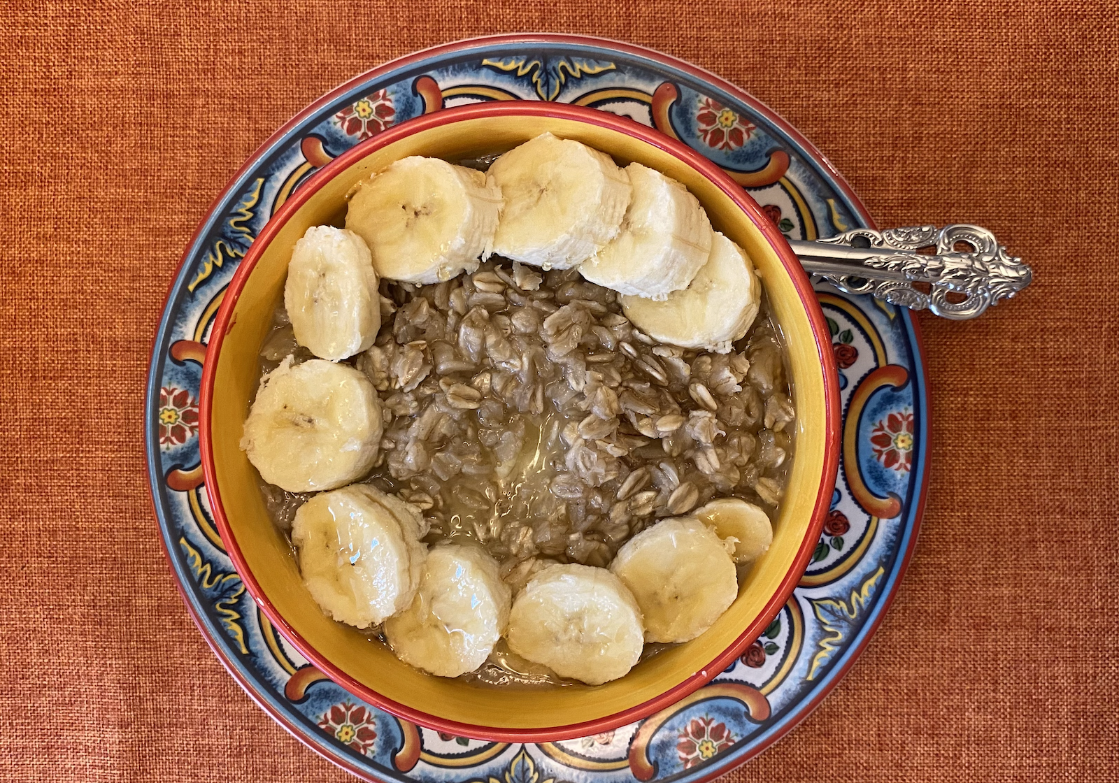 Cinnamon oatmeal in a bowl topped with bananas