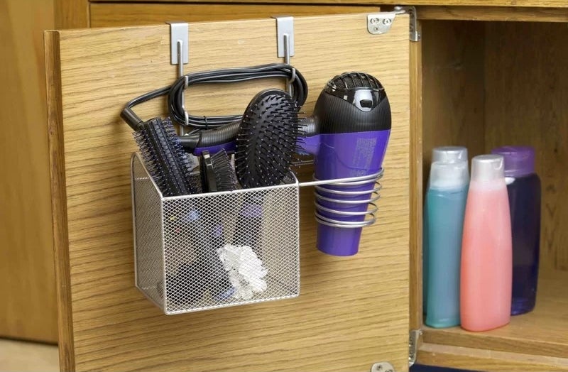 A metal hair tool organizer hanging over the door