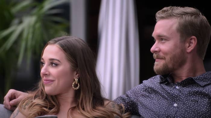 Lauren and Nate sit side-by-side and smile in this screenshot from "The Ultimatum"