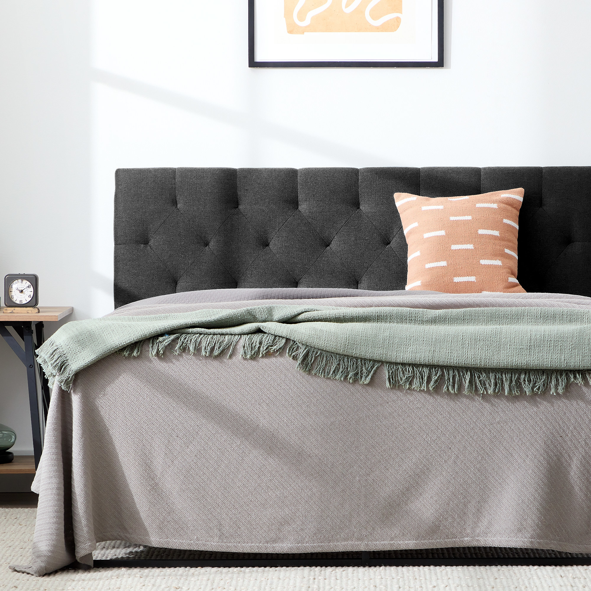 An image of a charcoal diamond tufted upholstered headboard available in sizes Twin—King