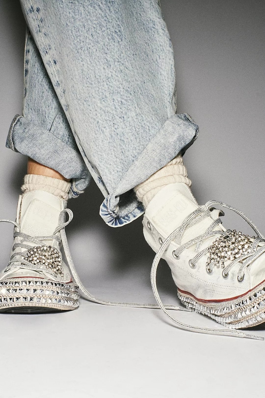 white converse with bedazzled details and studded soles