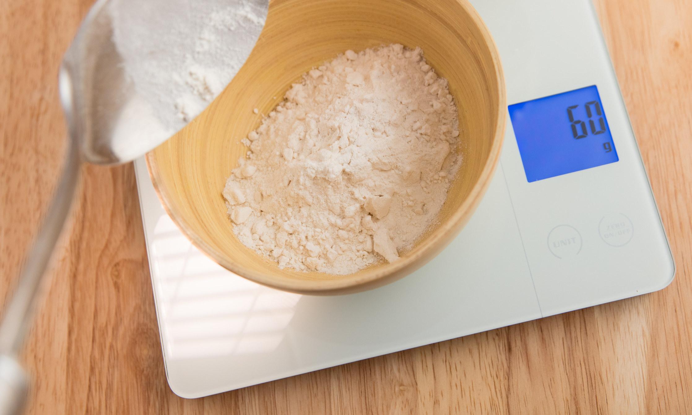 Weighing flour in a bowl on a kitchen scale