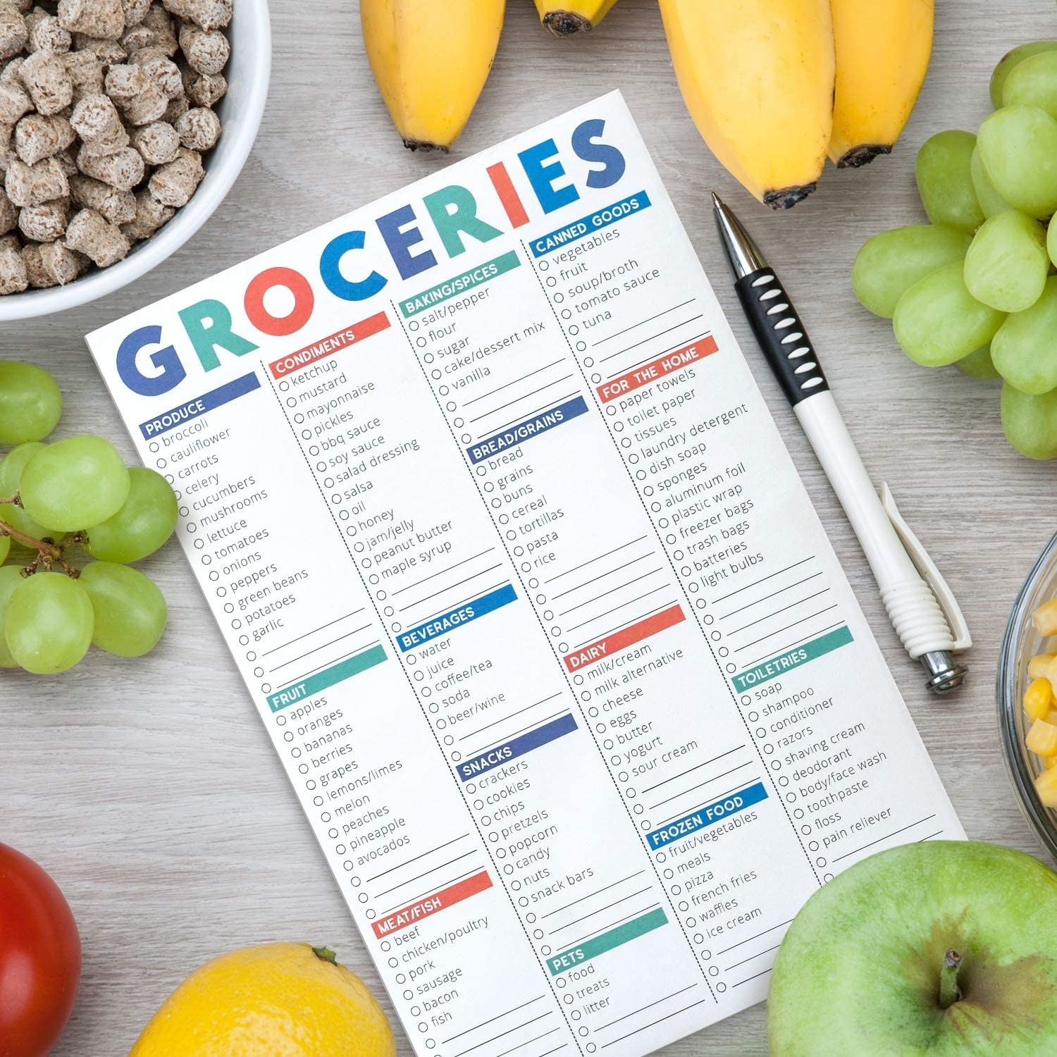 A notepad with a grocery checklist on it
