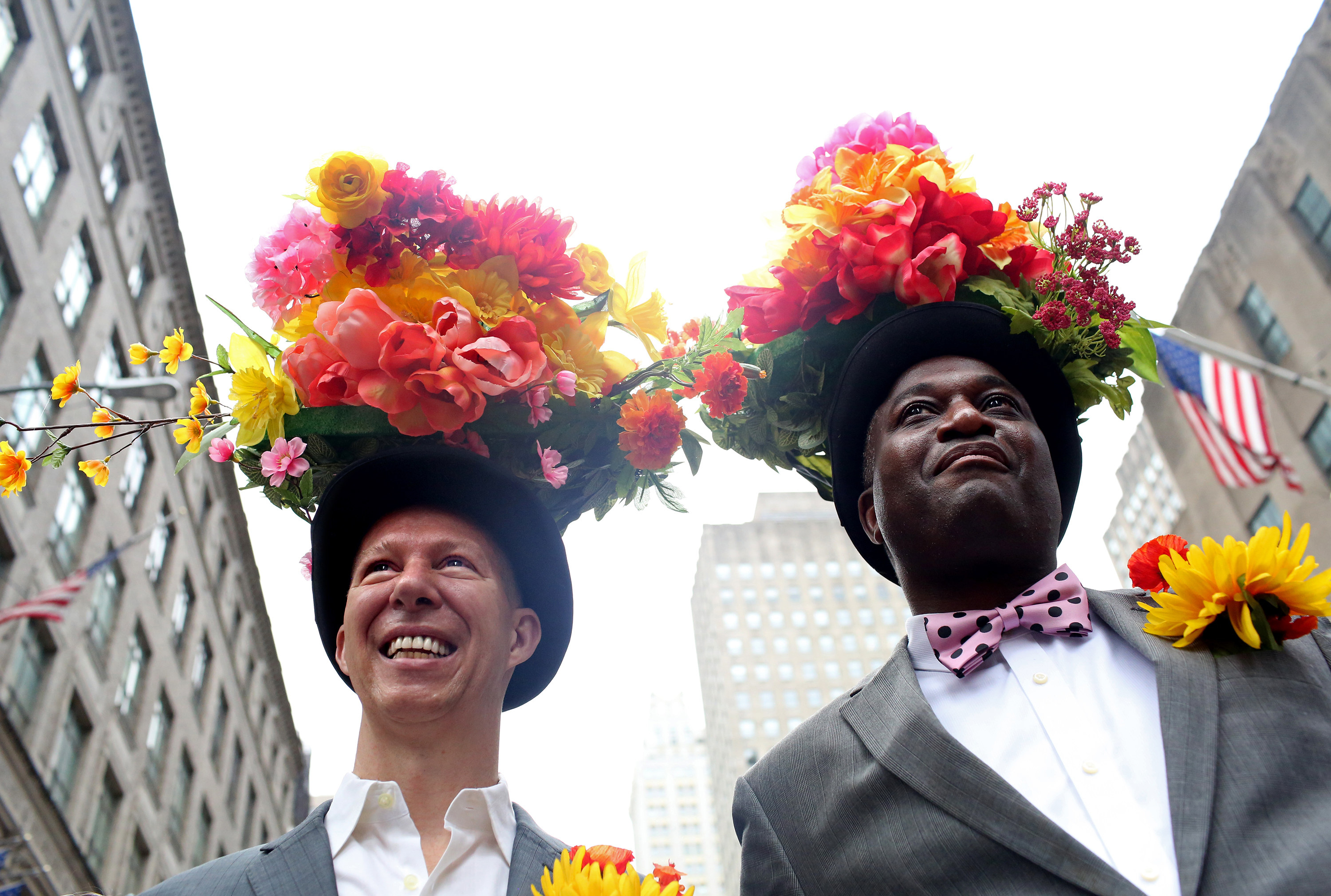 Two men with top hats covered in flowers