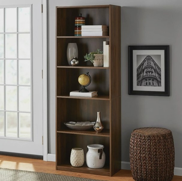 An image of a five-shelf bookcase featuring two fixed shelves and three adjustable shelves