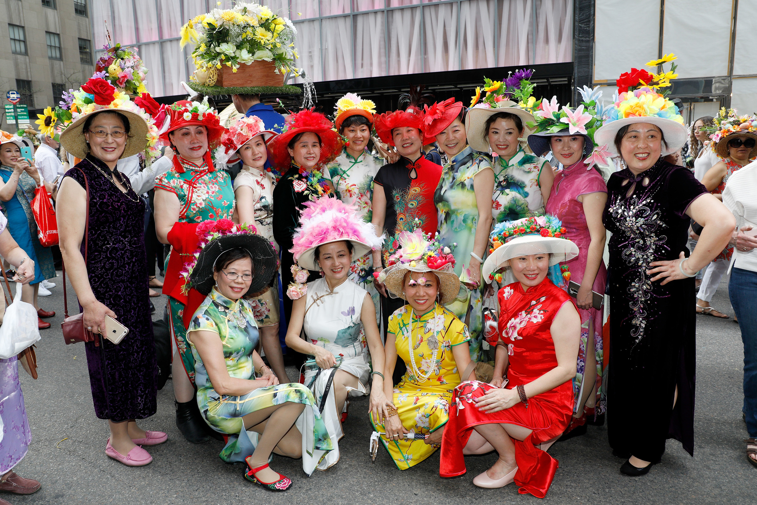 A group of women, some kneeling, smile in their Easter Sunday best