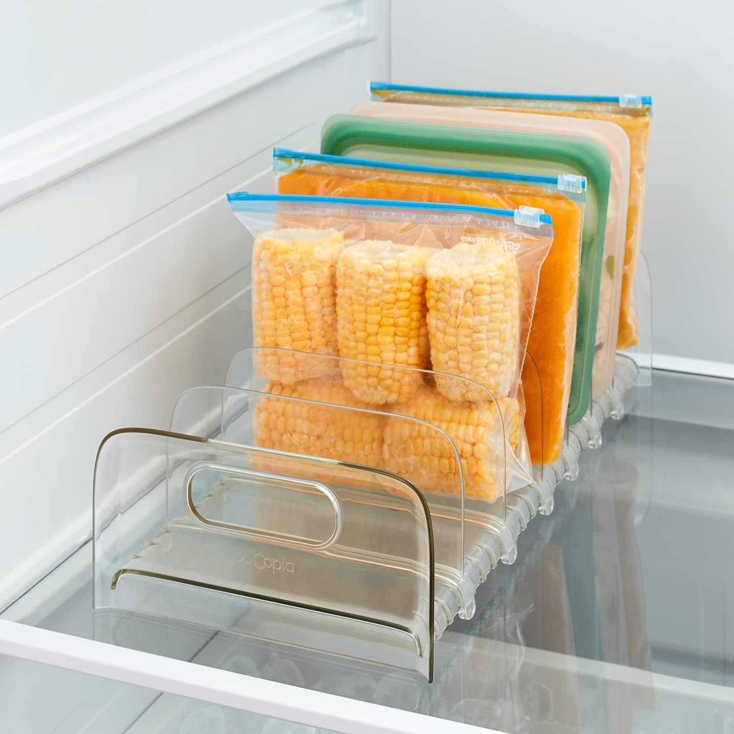A plastic organizer on a shelf with boxes and bags of food in it
