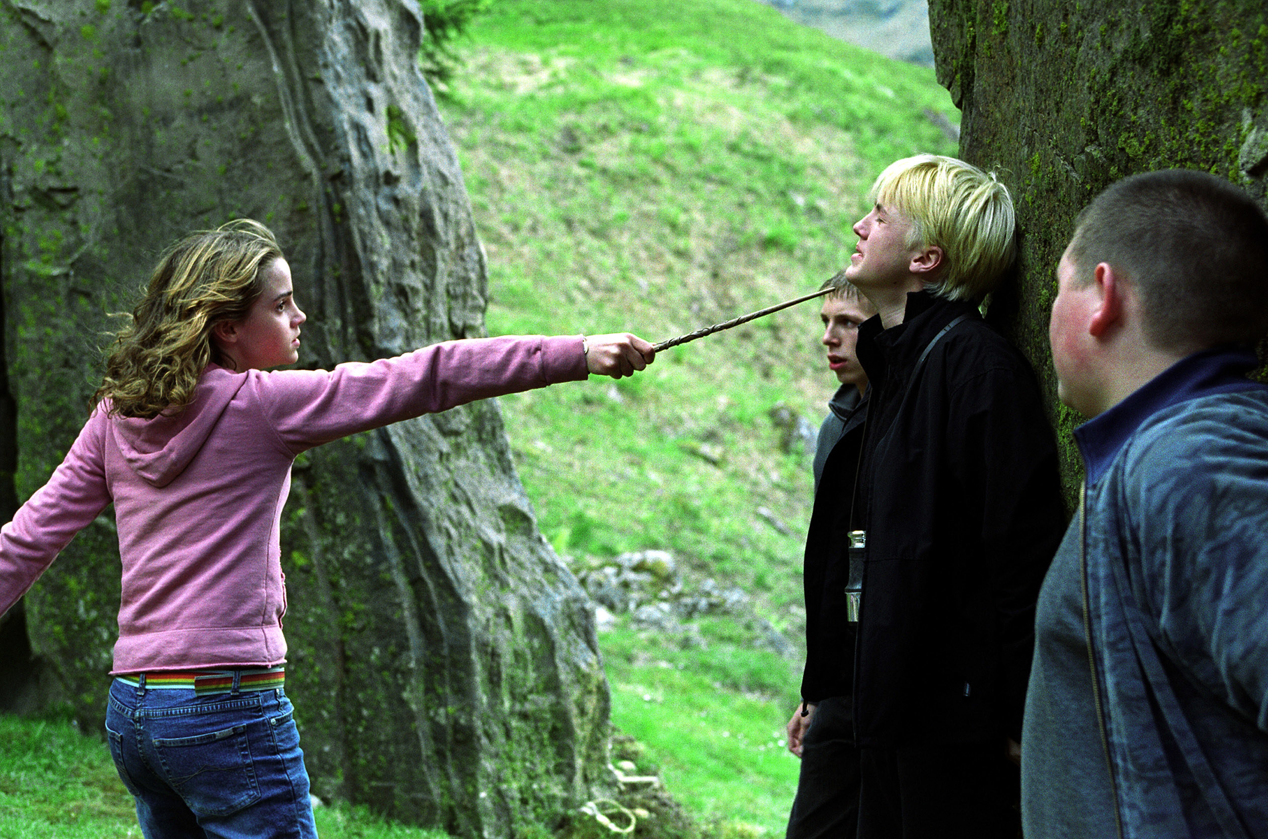 Hermione pointing a wand at Draco