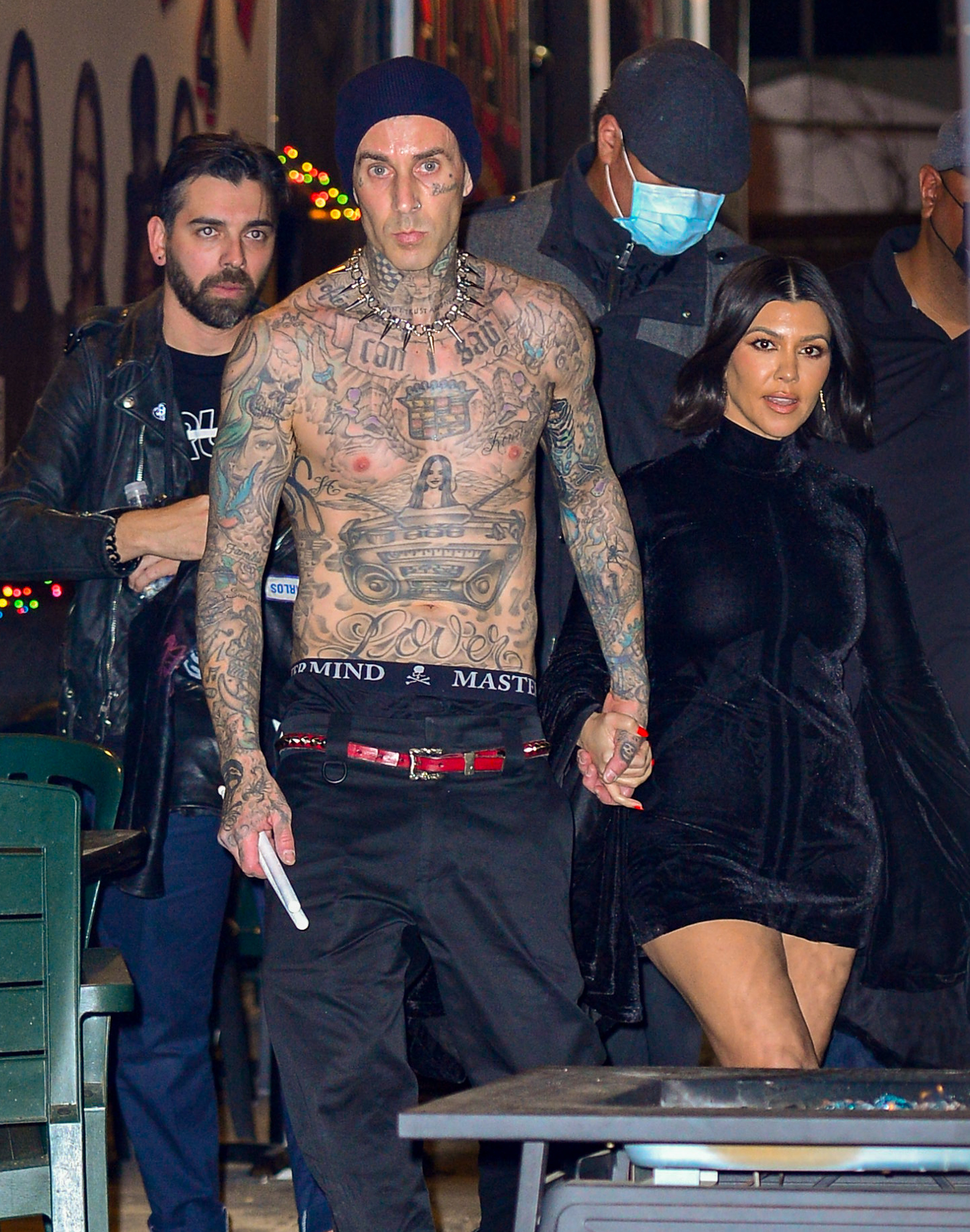 Travis holds Kourtney&#x27;s hand while shirtless