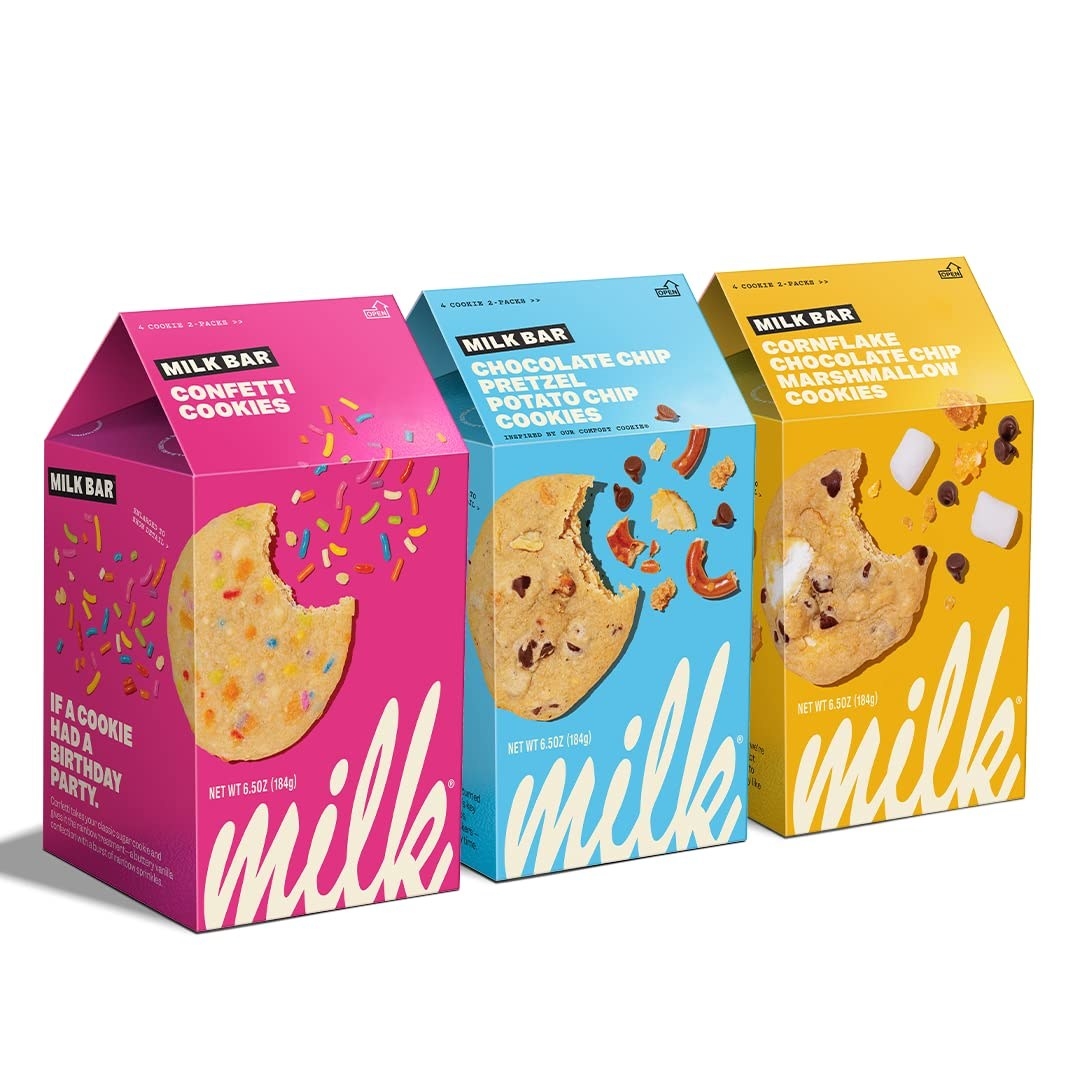 three boxes that have different cookies on them: one is a sugar cookie with sprinkles, one is a chocolate chip cookie with pretzels, and the third is a choc chip cookie with marshmallows