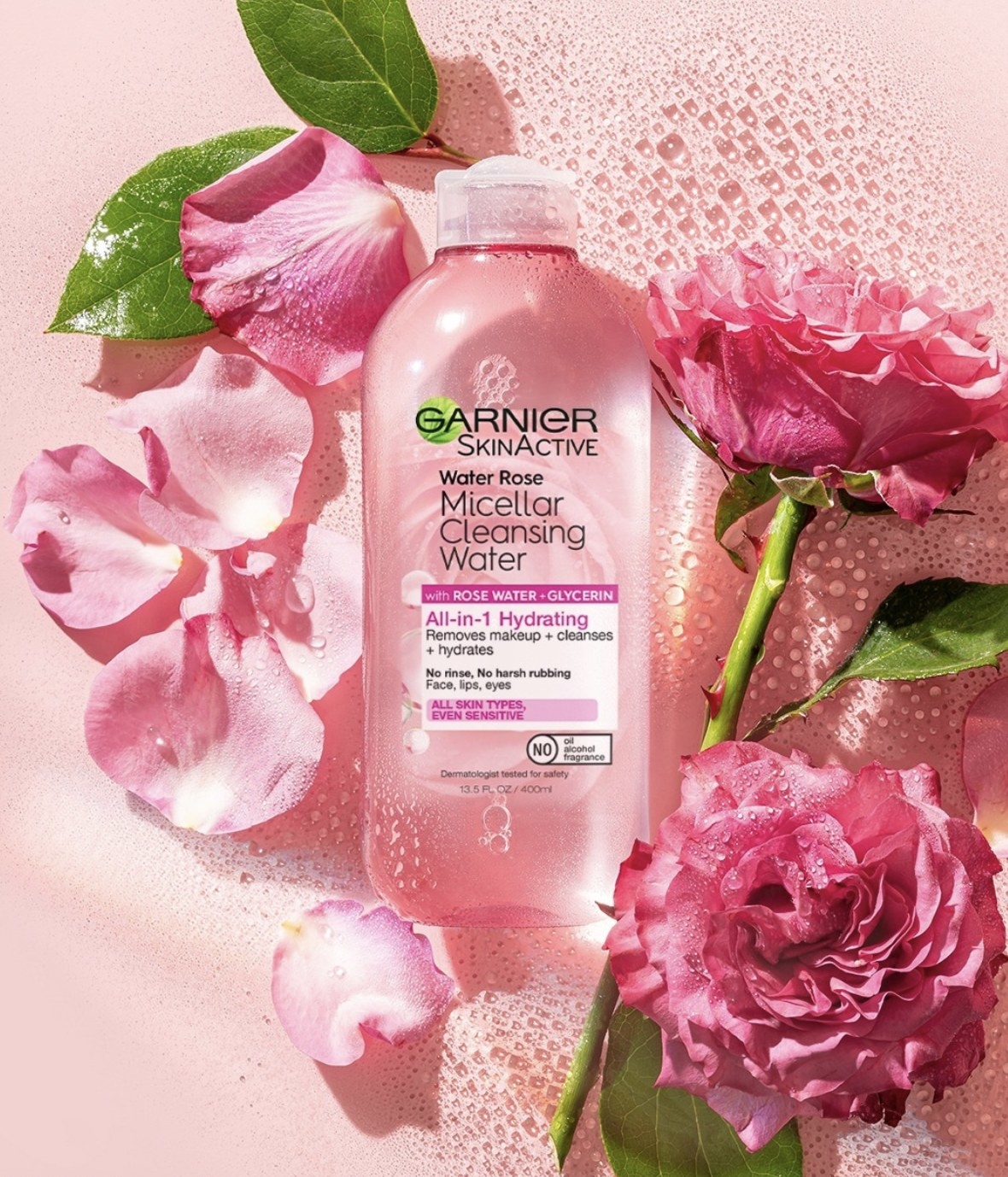 the micellar water next to pink roses and rose petals