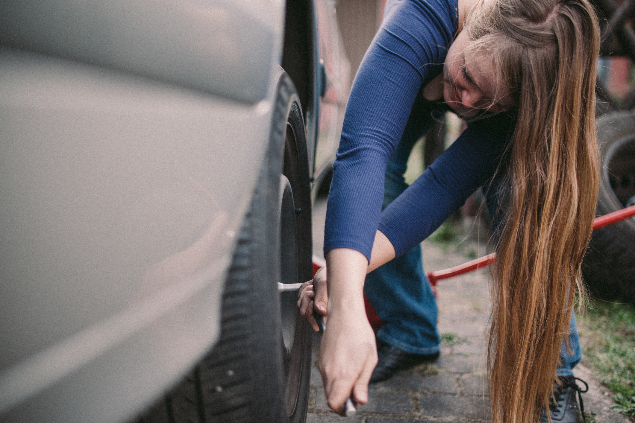 A woman changing a tire