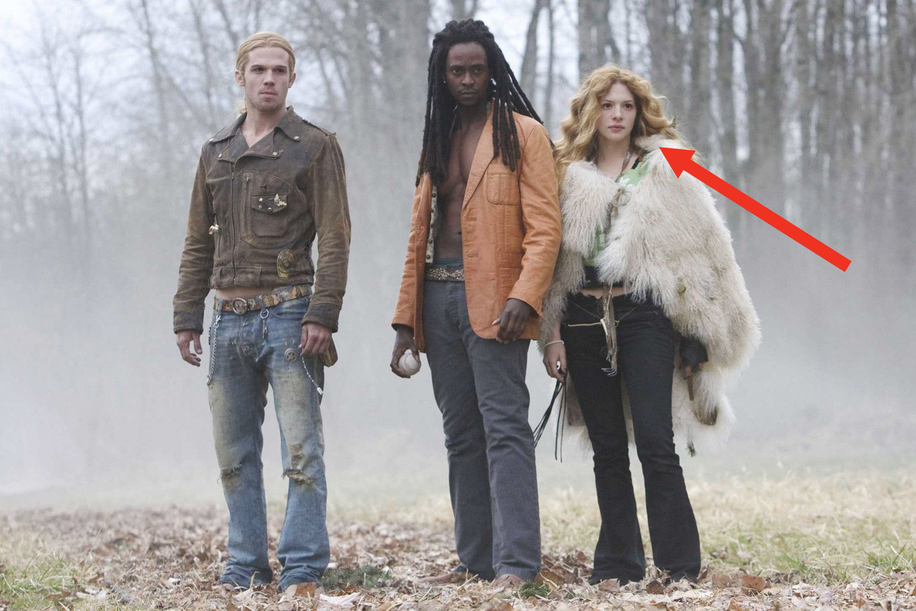 three vampires stand in a clearing with an arrow pointing to Rachelle