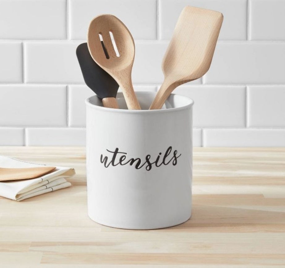 A white utensil container with &quot;utensils&quot; written in black cursive