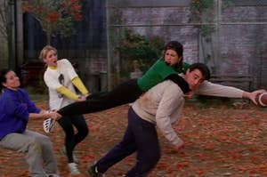 Monica and Phoebe hold onto Rachel's feet as she's on Joey's back as he holds a football