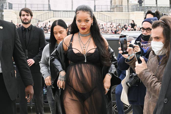 Rihanna walking though a sea of paparazzi in lingerie flaunting off her beautiful pregnant belly