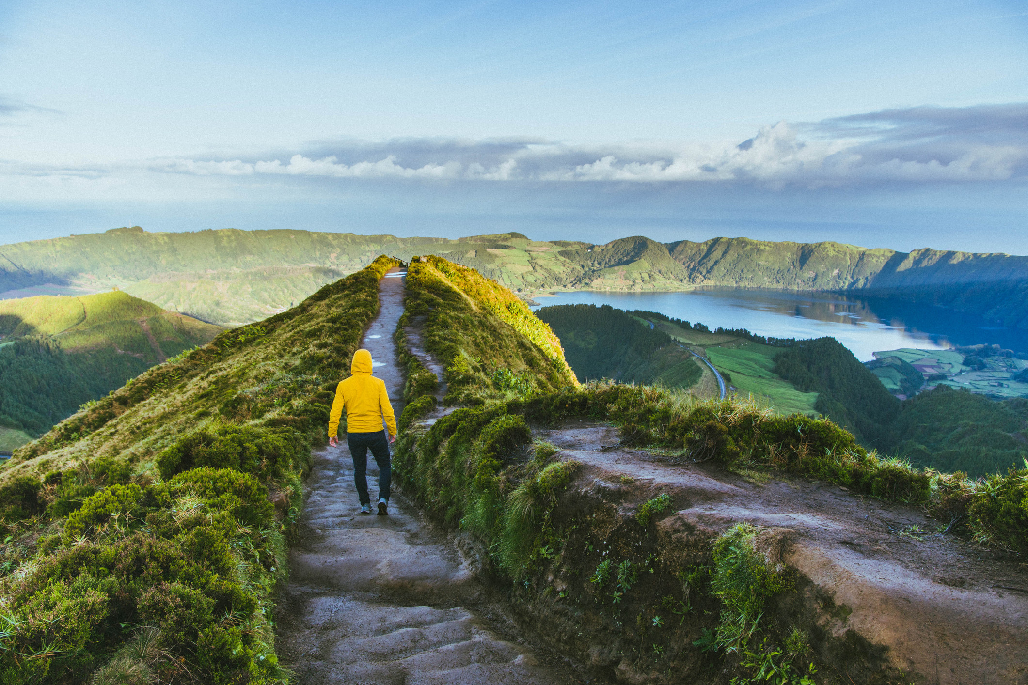 A hiker in a yellow rainjacket.