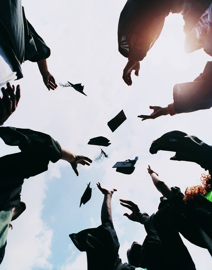 Graduates tossing their caps into the air.