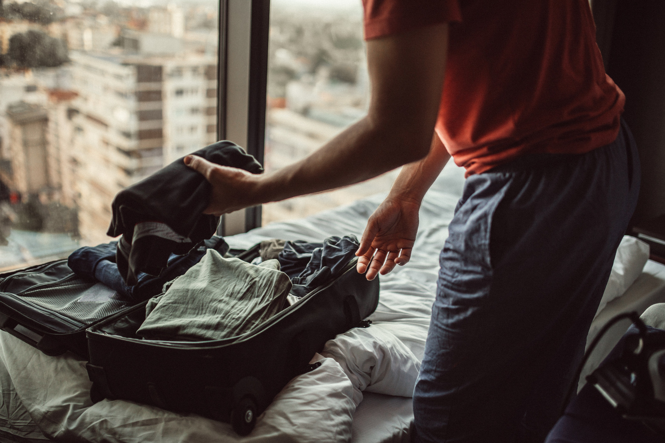 A man packing a suitcase.