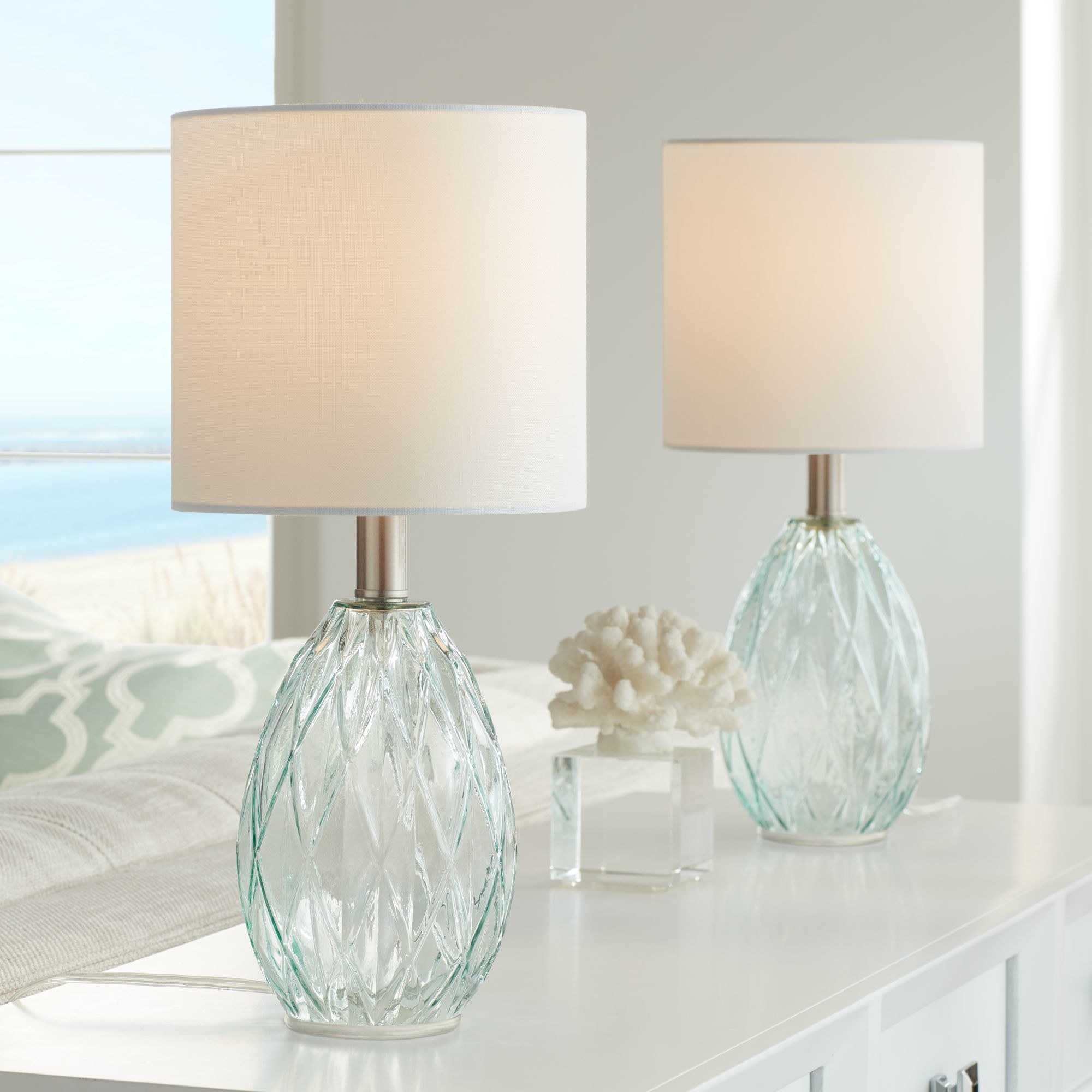 The two diamond blue-green bedroom lamps with a white-beige lamp shades