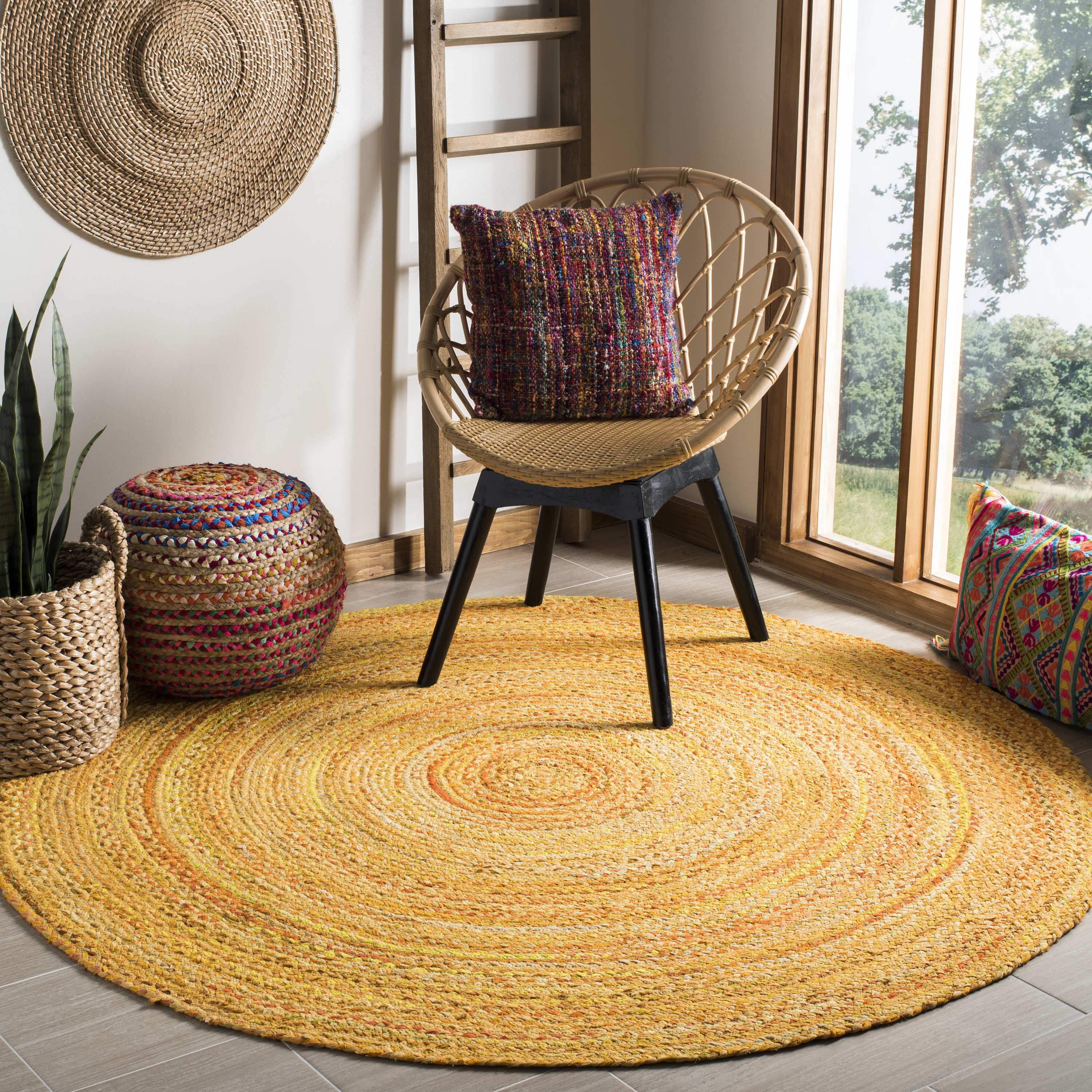 An image of a round braided area rug in a gold color