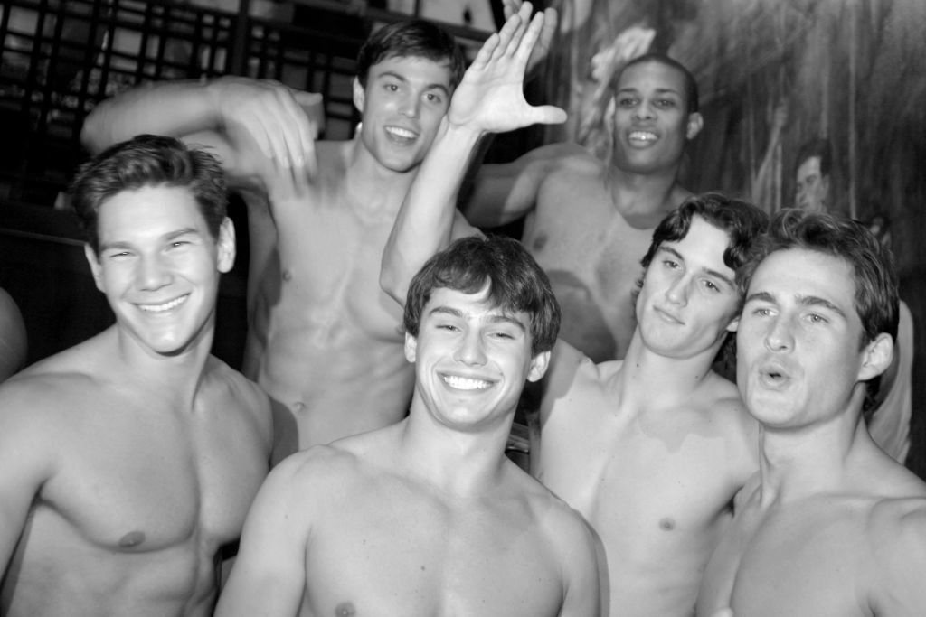 a group of shirtless employees with no facial hair