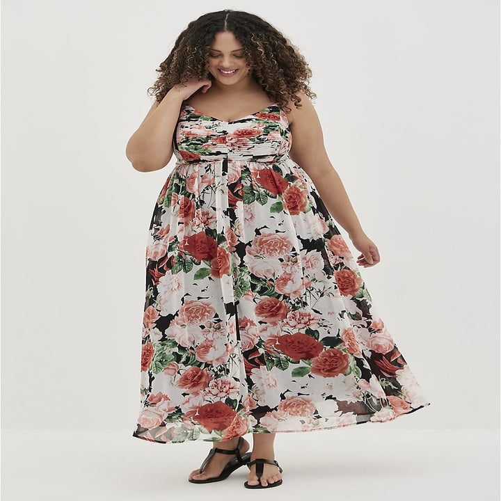 Model wearing floral maxi dress and black sandals