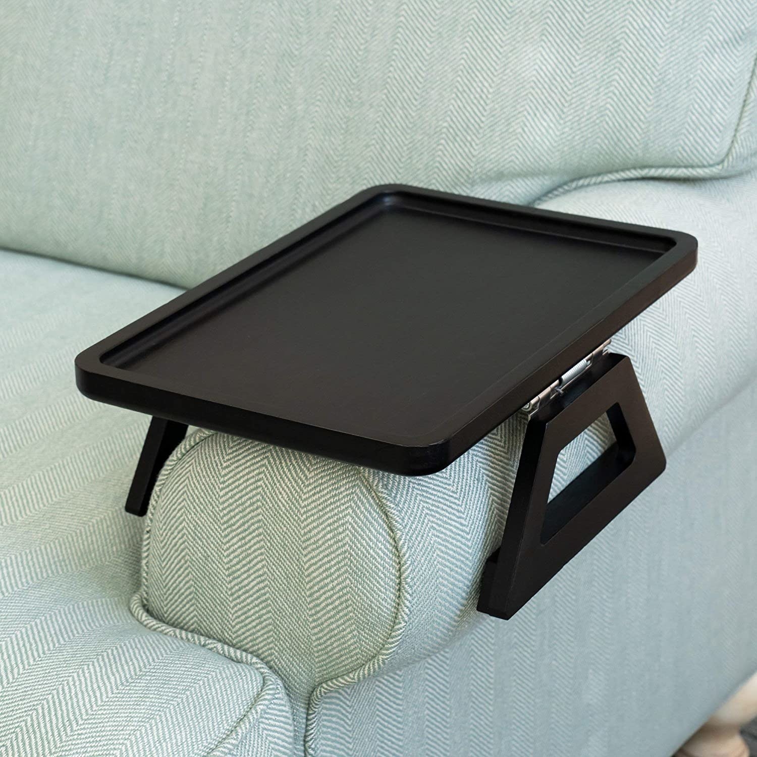 The tray on the arm of a couch in a living room