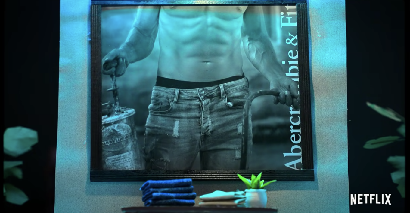 dark entrance to the store with a poster of a shirtless model