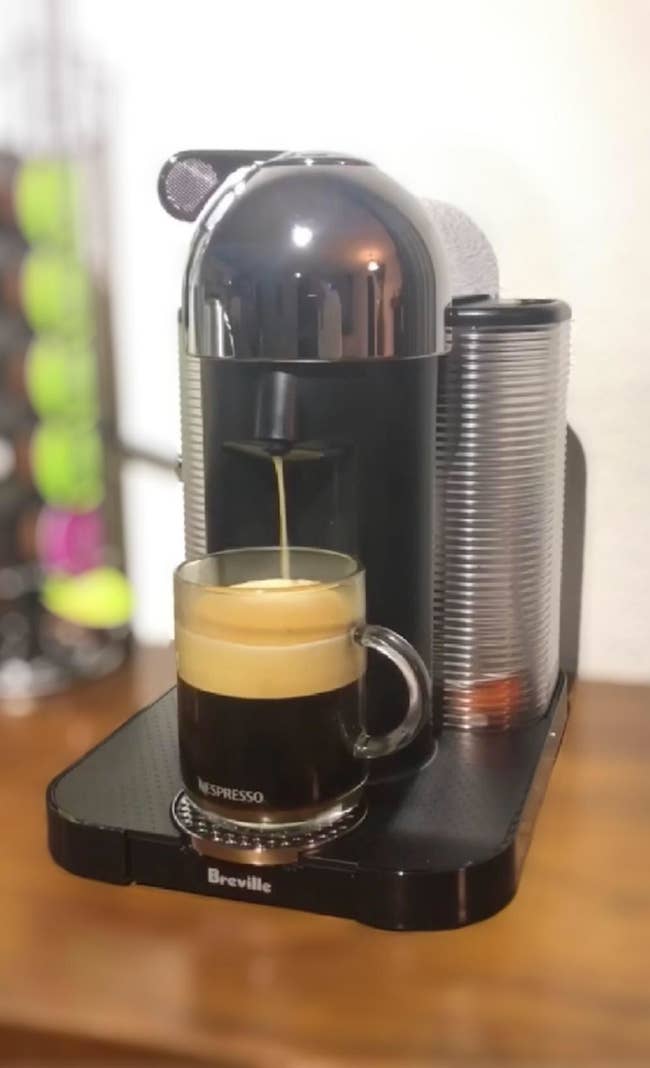 Reviewer pic of the machine brewing a cup of coffee