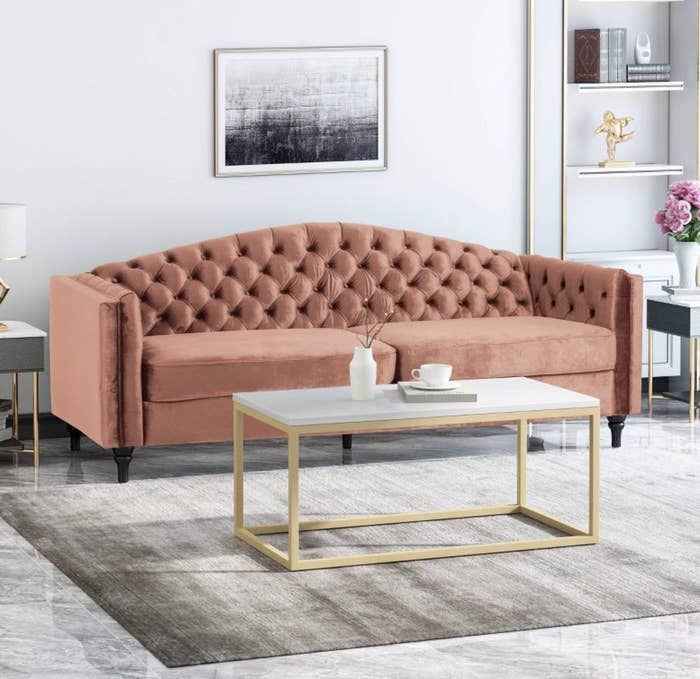 A pink velvet tufted couch