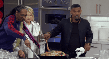 Martha, Snoop, and friends cooking in a giant pan